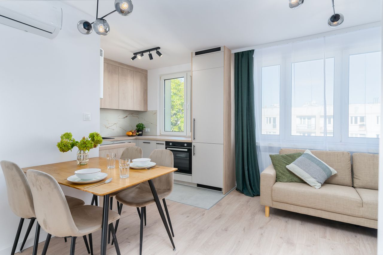 services-01 Bright kitchen with dining area in Scandinavian style, featuring minimalist design.